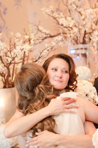 Bride hugging bridesmaids