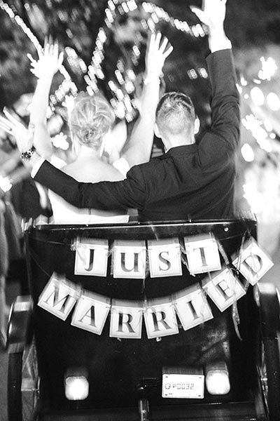 bride and groom riding in a pedicab at wedding ceremony at outdoor Portland wedding venue