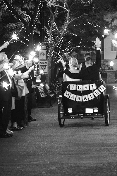close up of bride and groom riding in a pedicab at wedding ceremony at outdoor Portland wedding venue