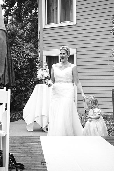 bride and little girl walking down the aisle at wedding ceremony