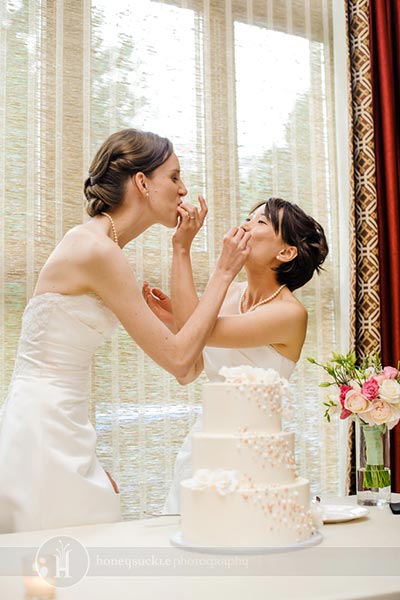 brides feeding cake to each other